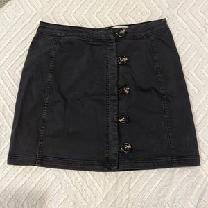 Black mini skirt with tortoise buttons